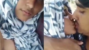 A Muslim girl in a hijab enjoys breast sucking from her lover
