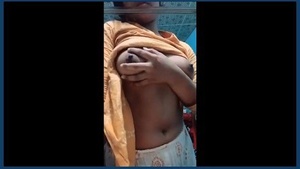 A charming Indian girl proudly displays her breasts