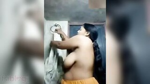 Watch a curvy Indian MILF strip and show off her big breasts in a steamy MMS video
