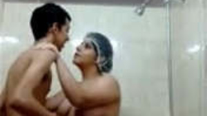 Aunty with large breasts gives oral pleasure to a satisfied young boy in the shower