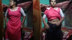 A country girl records a video for her lover in a village setting
